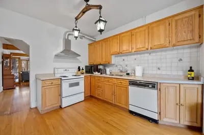 a kitchen with white appliances and wooden cabinets at Picturesque & Serene Gem in Port Credit - Steps to Lake - Backyard in Mississauga