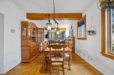 a kitchen and dining room with a wooden table and chairs at Picturesque & Serene Gem in Port Credit - Steps to Lake - Backyard in Mississauga
