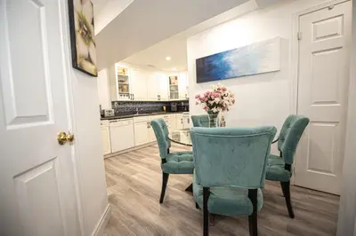 a dining room with a table and green chairs at Luxury 2BR Guest Suite in Vaughan