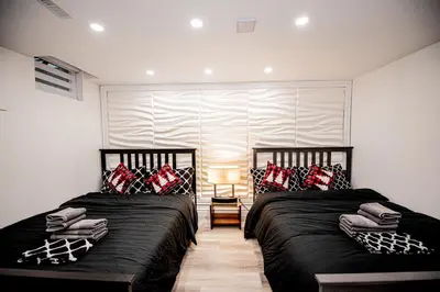 two beds sitting next to each other in a bedroom at Luxury 2BR Guest Suite in Vaughan