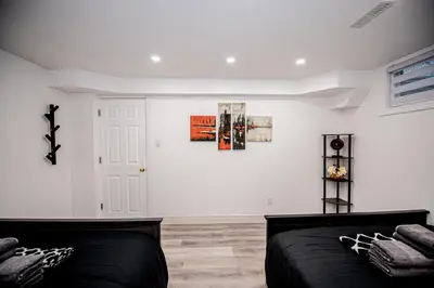a bedroom with a bed and a white wall at Luxury 2BR Guest Suite in Vaughan