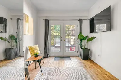 a living room with a couch and a table at Hot Tub Haven in Toronto