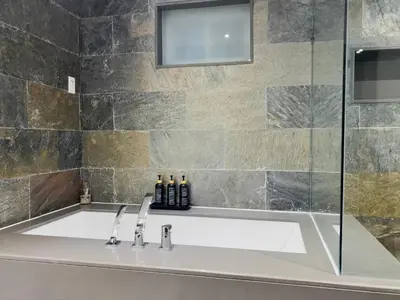 a bathroom with a sink and a shower at Hot Tub Haven in Toronto