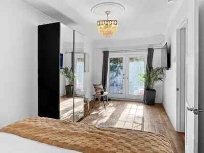 a bedroom with a mirror and a bed in it at Hot Tub Haven in Toronto