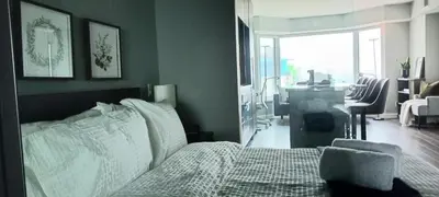 a bedroom with a bed with a chair and a desk at Elegant 2BR & 2BA Retreat in Prime Yorkville, Downtown in Toronto