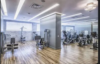 a gym with several treadmills and cardio machines at Elegant 2BR & 2BA Retreat in Prime Yorkville, Downtown in Toronto