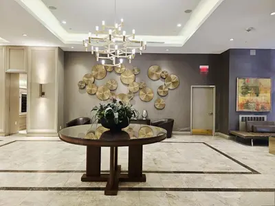 a dining room with a table and a chandelier at Elegant 2BR & 2BA Retreat in Prime Yorkville, Downtown in Toronto