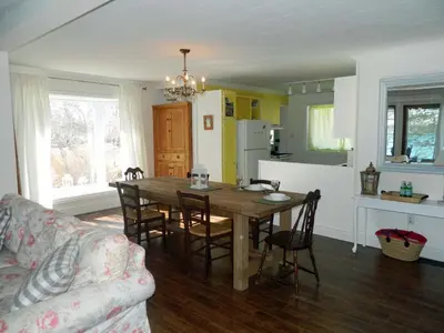 a kitchen and dining room with a table and chairs at Cute and Cozy Lakefront Cottage in Wellington
