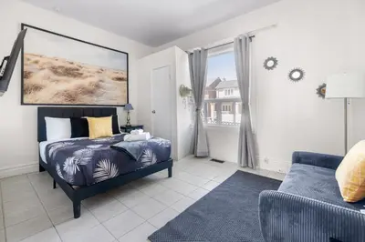 a bedroom with a bed and a couch at Stylish & Inviting Private Bedroom in Corso Italia in Toronto