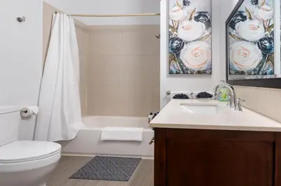a bathroom with a sink and a toilet and a shower at Stylish & Inviting Private Bedroom in Corso Italia in Toronto