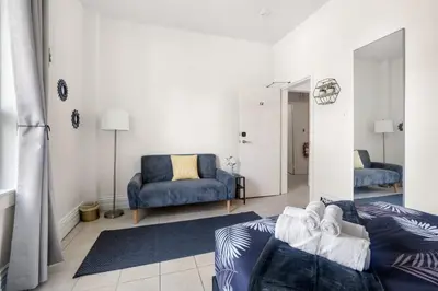 a living room with a couch and a chair at Stylish & Inviting Private Bedroom in Corso Italia in Toronto