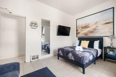 a bedroom with a bed and a large painting on the wall at Stylish & Inviting Private Bedroom in Corso Italia in Toronto