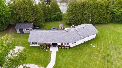 an aerial view of a large white house at Deer Run Cottage- Golf Course cottage in Kawartha Lakes