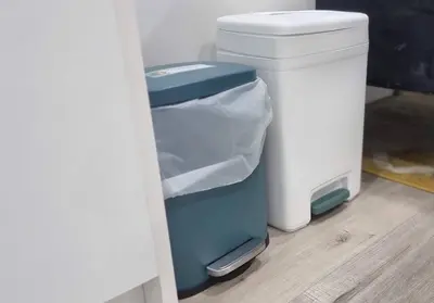 a blue trash can next to a white trashcan at Moons & Noons -Separate Unit for your Comfort in Ajax