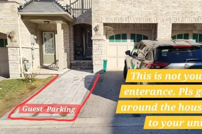 a sign in front of a house with a car at Moons & Noons -Separate Unit for your Comfort in Ajax