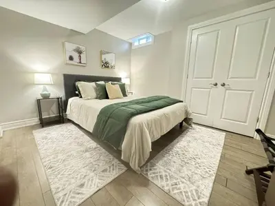 a bedroom with a bed with a green blanket at Cosy Guest Suite Near Shops, Transit, Hwy and GO! in Mississauga