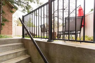 a set of stairs next to a wrought iron fence at Cosy Guest Suite Near Shops, Transit, Hwy and GO! in Mississauga