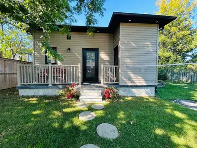 a small house with a porch and a yard at The Grassy Oasis in Brampton