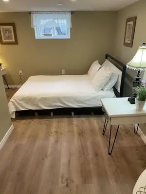 a bedroom with a bed and a table at Exceptionally Close to the Falls Amazing Location & Complimentary Breakfast Delivered Daily to the Rental in Niagara Falls