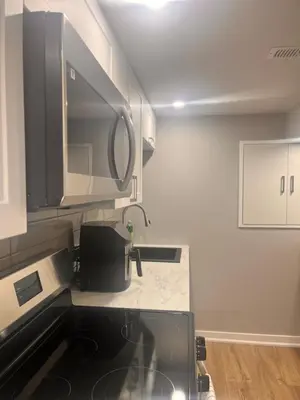 a kitchen with a sink and a microwave at Bowmanville basement apartment in Bowmanville