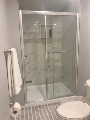 a glass shower in a bathroom with a toilet at Bowmanville basement apartment in Bowmanville