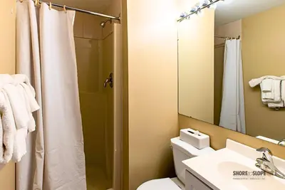a bathroom with a shower and a toilet and a sink at Mountain View Villas One Bed Loft Suite in Collingwood