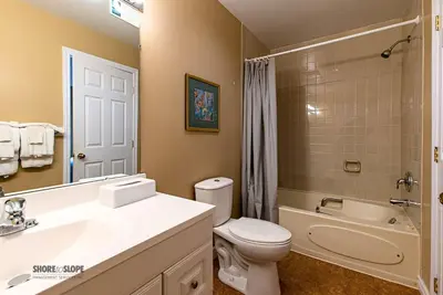 a bathroom with a sink and a toilet and a bath tub at Mountain View Villas One Bedroom Suite in Collingwood