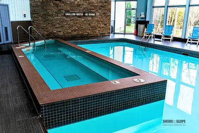 a large swimming pool in a building at Mountain View Villas One Bedroom Suite in Collingwood