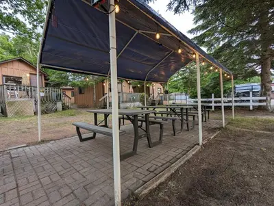 a group of picnic tables under a tent at Tiny Wood Cottage 05 in Wasaga Beach