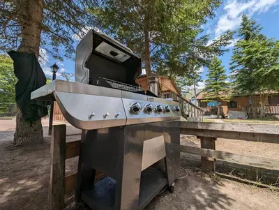a stove top oven sitting next to a wooden fence at Tiny Wood Cottage 11 in Wasaga Beach