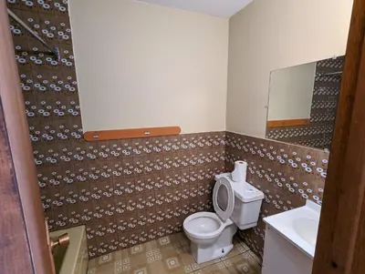 a bathroom with a toilet and a sink at Tiny Wood Cottage 16 in Wasaga Beach