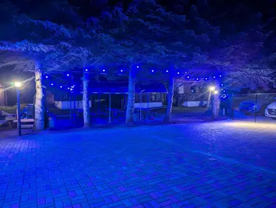 a night view of a park with blue lights at Tiny Wood Cottage 17 in Wasaga Beach