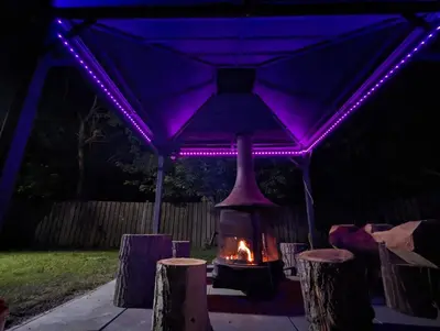 a fireplace under a tent with purple lights at Tiny Wood Cottage 17 in Wasaga Beach