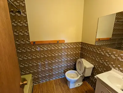 a bathroom with a toilet and a sink at Tiny Wood Cottage 18 in Wasaga Beach