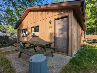 a picnic table outside of a tiny house at Tiny Wood Cottage 20 in Wasaga Beach