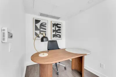 an office with a wooden desk and a lamp at The Royal 2 Bedroom Condo Yorkville in Toronto