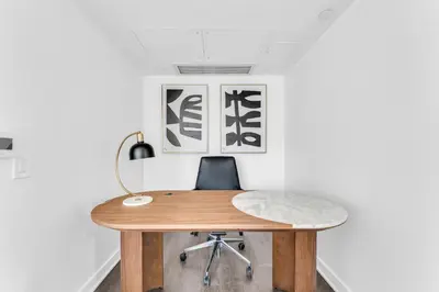 an office with a wooden desk and a chair at The Royal 2 Bedroom Condo Yorkville in Toronto