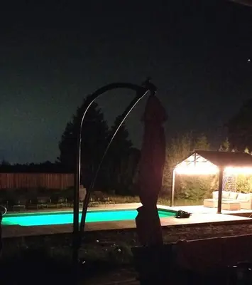 a water fountain in front of a pool at night at Alba Cottage with Brand New Pool in Queenston