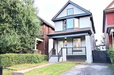 a white house with a black roof at Modern Luxury Home next to Tim Hortons Field in Hamilton
