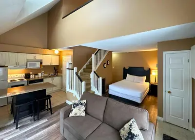 a living room with a couch and a bed at Mountain Loft Suite with Pool and Hot Tub in Blue Mountains