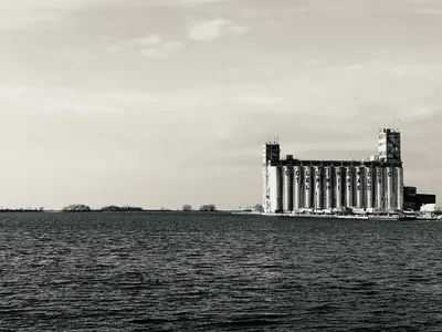 a black and white photo of a building on the water at The Family Escape Townhome in Collingwood