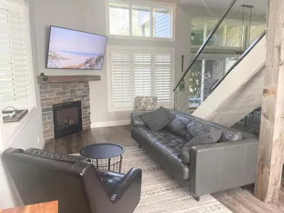 a living room with a couch and a fireplace at The Family Escape Townhome in Collingwood
