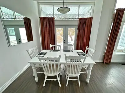 a white dining room with a white table and chairs at Four Season Family Retreat with Pool Access in Collingwood