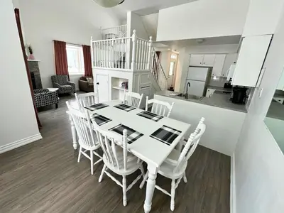 a dining room and kitchen with a white table and chairs at Four Season Family Retreat with Pool Access in Collingwood