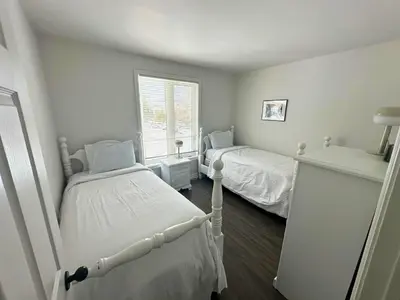 a bedroom with two twin beds and a window at Four Season Family Retreat with Pool Access in Collingwood