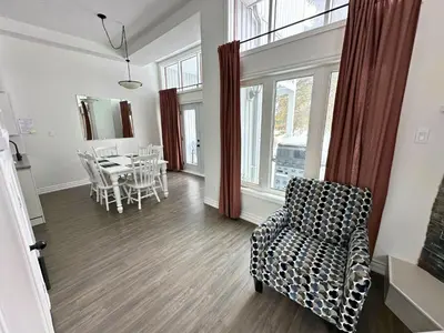 a living room with a chair and a table at Four Season Family Retreat with Pool Access in Collingwood