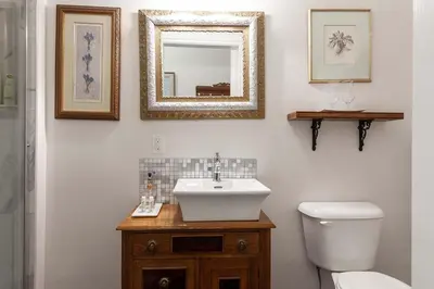 a bathroom with a sink and a toilet and a mirror at Stone Maiden Inn in Stratford
