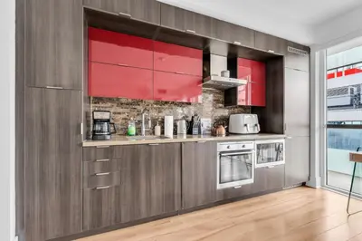 a kitchen with red cabinets and a counter at Estate 1 Bedroom Condo Front Street West in Toronto