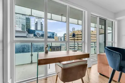 an office with a desk and large windows at Estate 1 Bedroom Condo Front Street West in Toronto