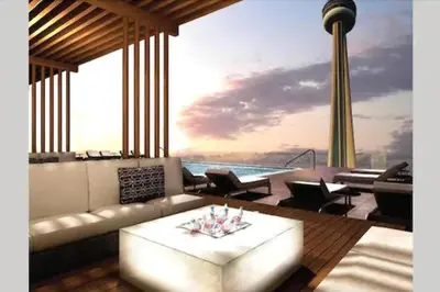a living room with a couch and a table at Skyline Suites - Walk to MTCC, ACC, Rogers Centre & Entertainment District in Toronto